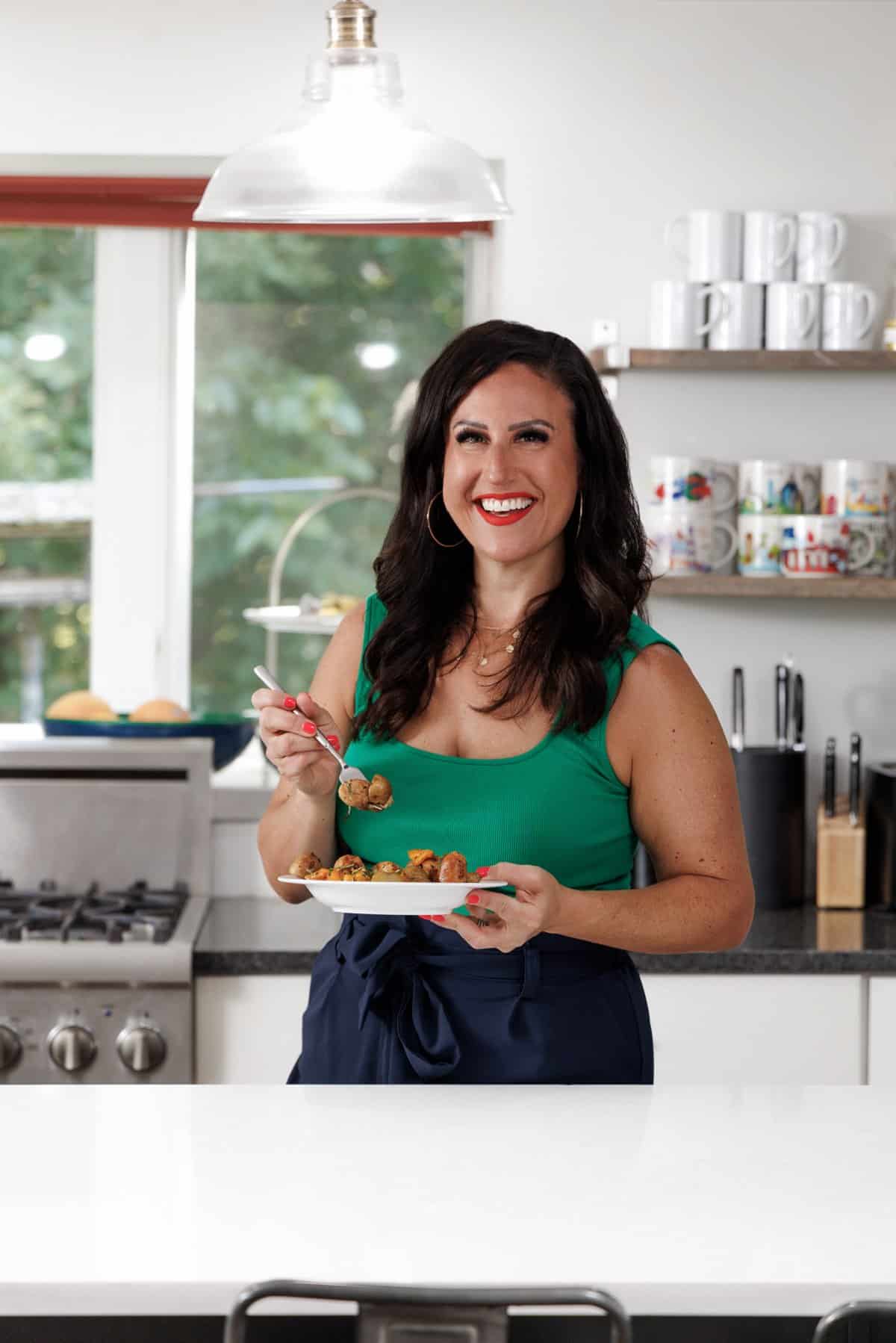 Liz eating grilled sausage, peppers, and potatoes.