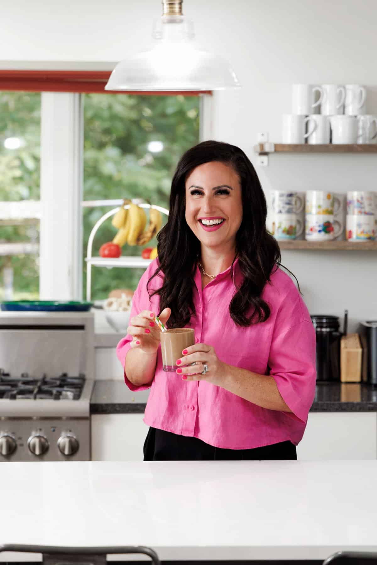 Liz drinking a low carb chocolate peanut butter smoothie.