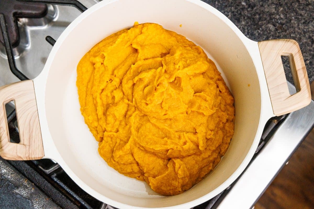 Roasted root vegetable puree in a white pot.