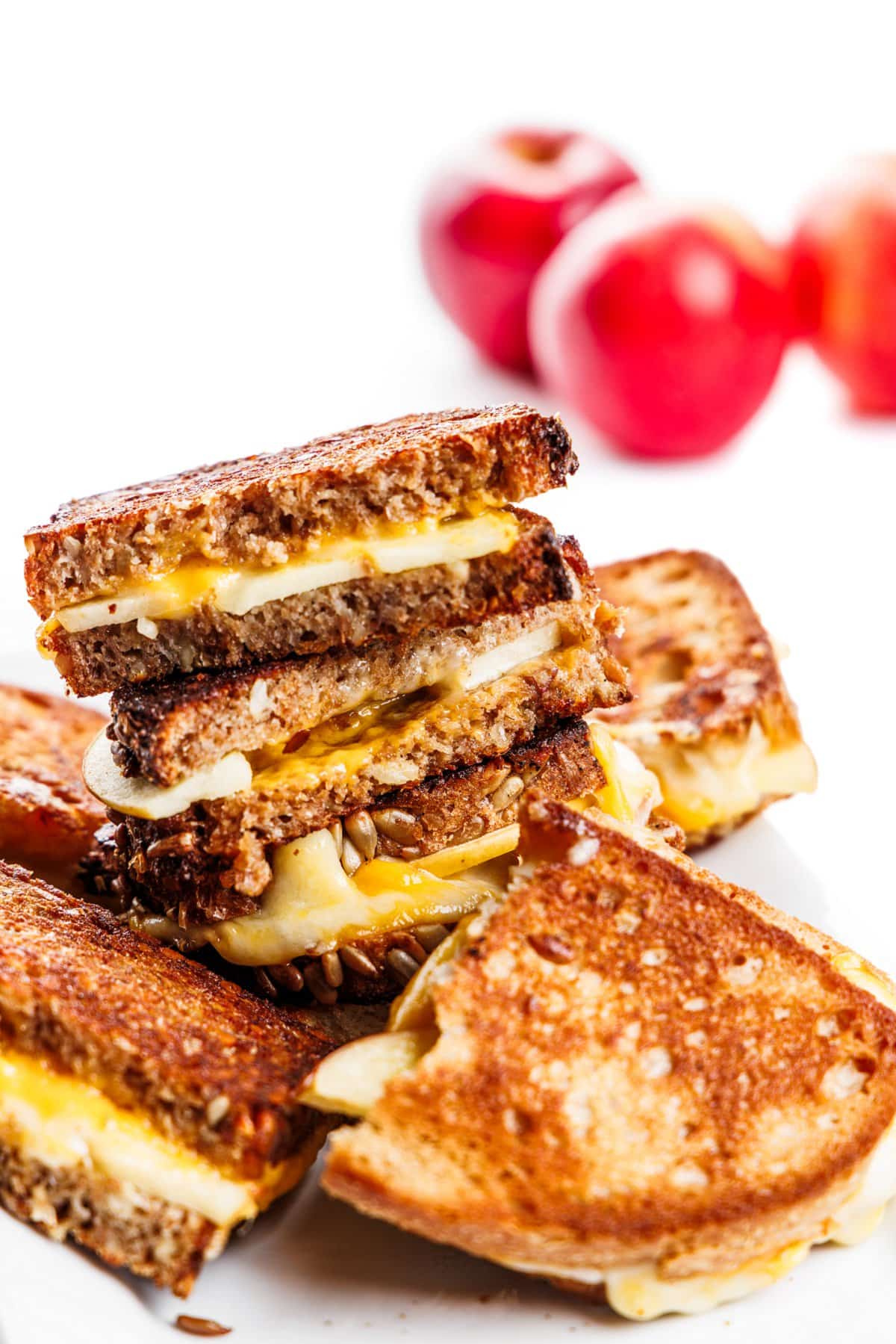 Grilled cheese sandwich with apples stacked on top of each other.