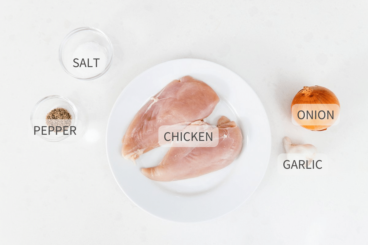 Ingredients for cooking chicken breasts laid out on a white background.