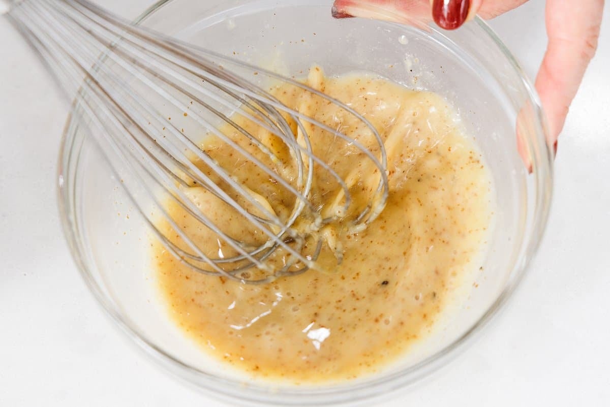 Whisking honey mustard sauce.