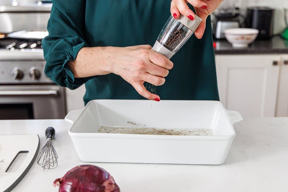 Seasoning beef in baking dish.