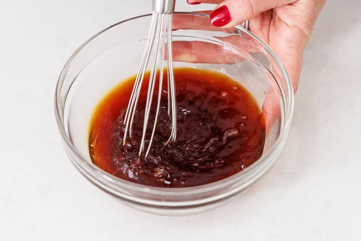 Whisking together soy salad dressing.