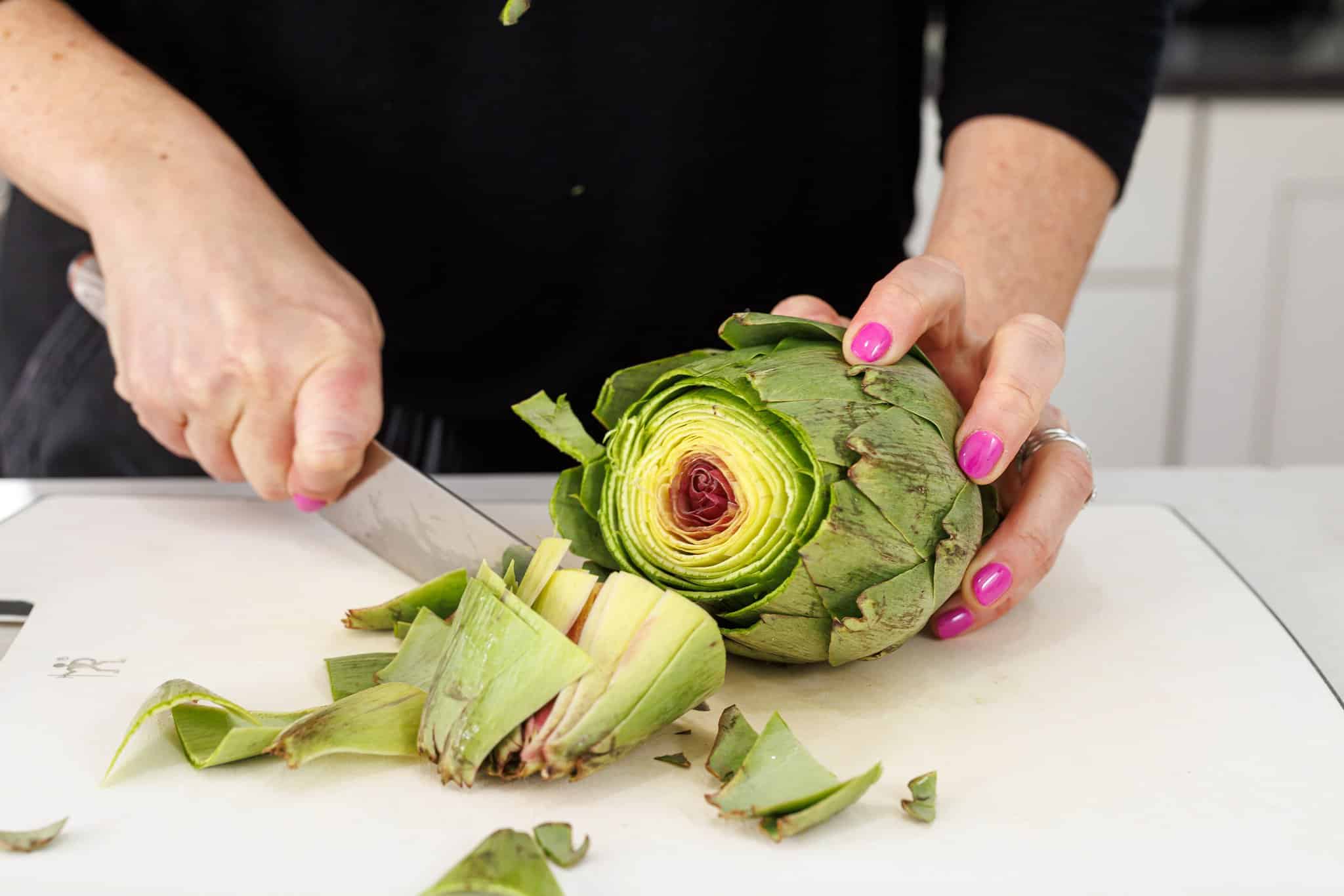Liz trimming an artichoke.