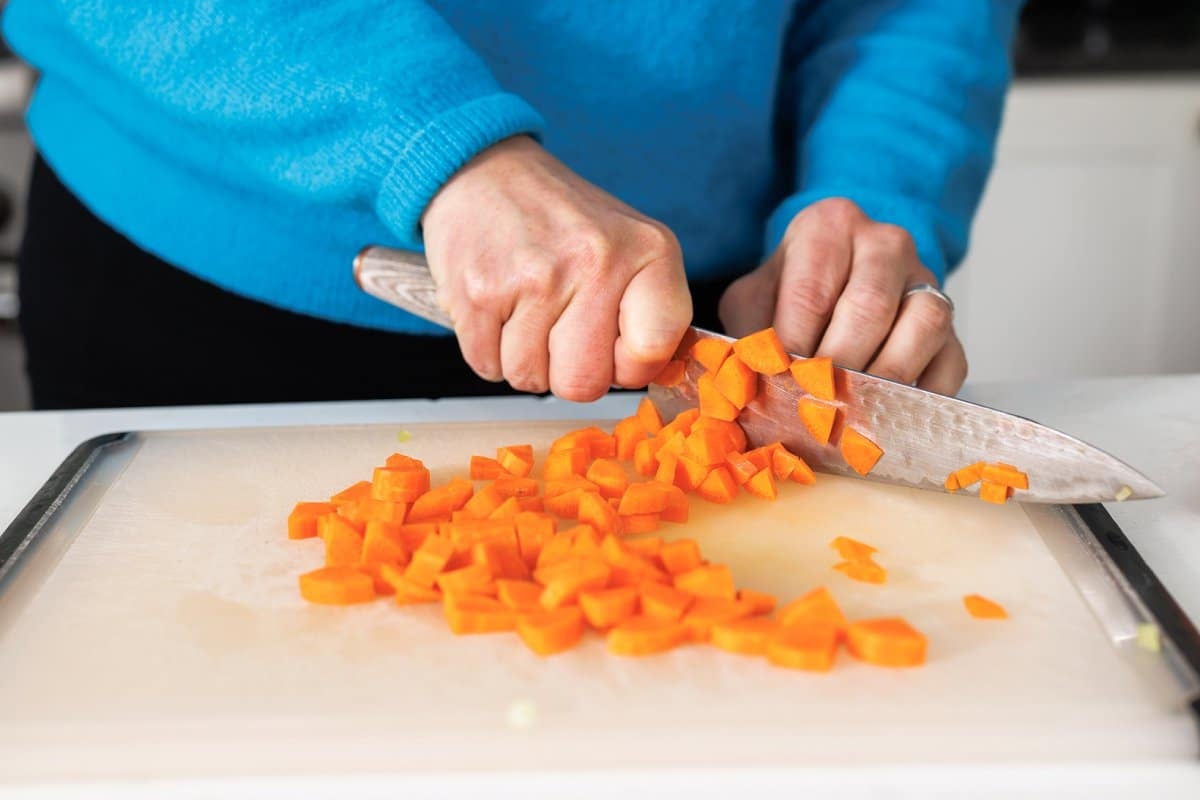 Chopping carrots.