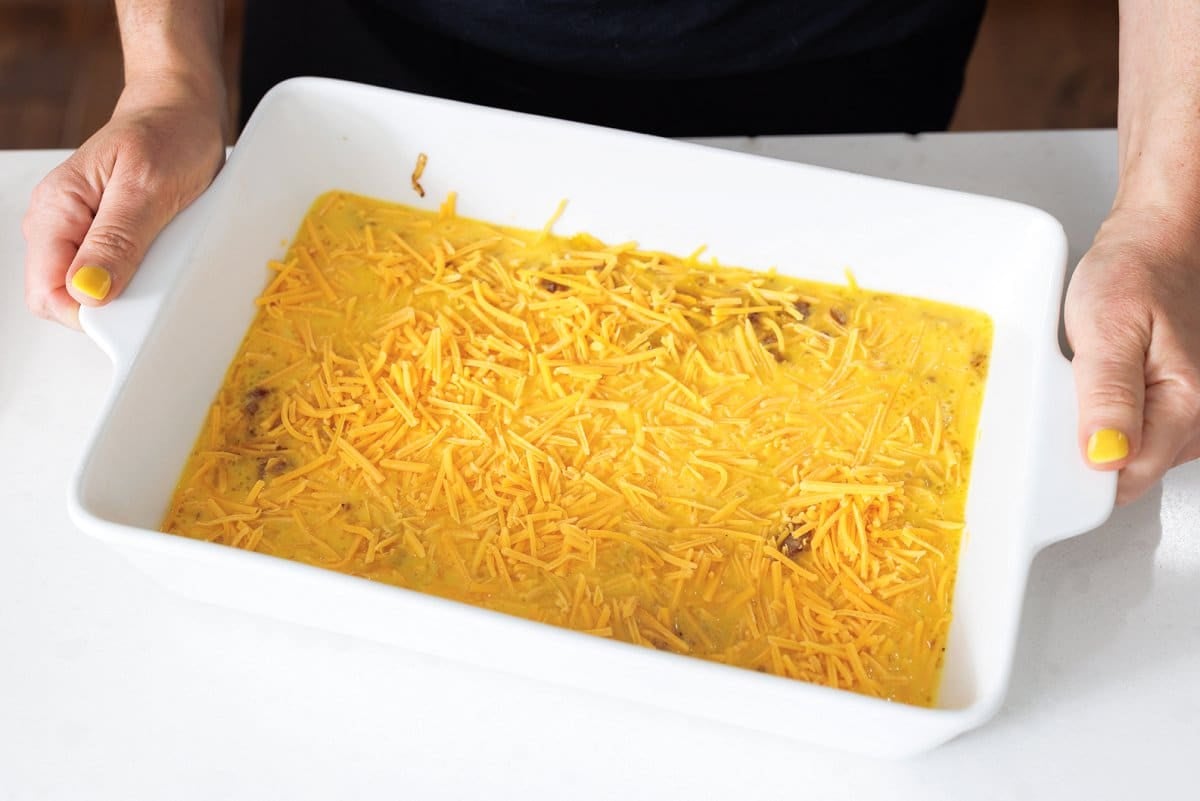 Egg bake sprinkled with cheese and ready for the oven.