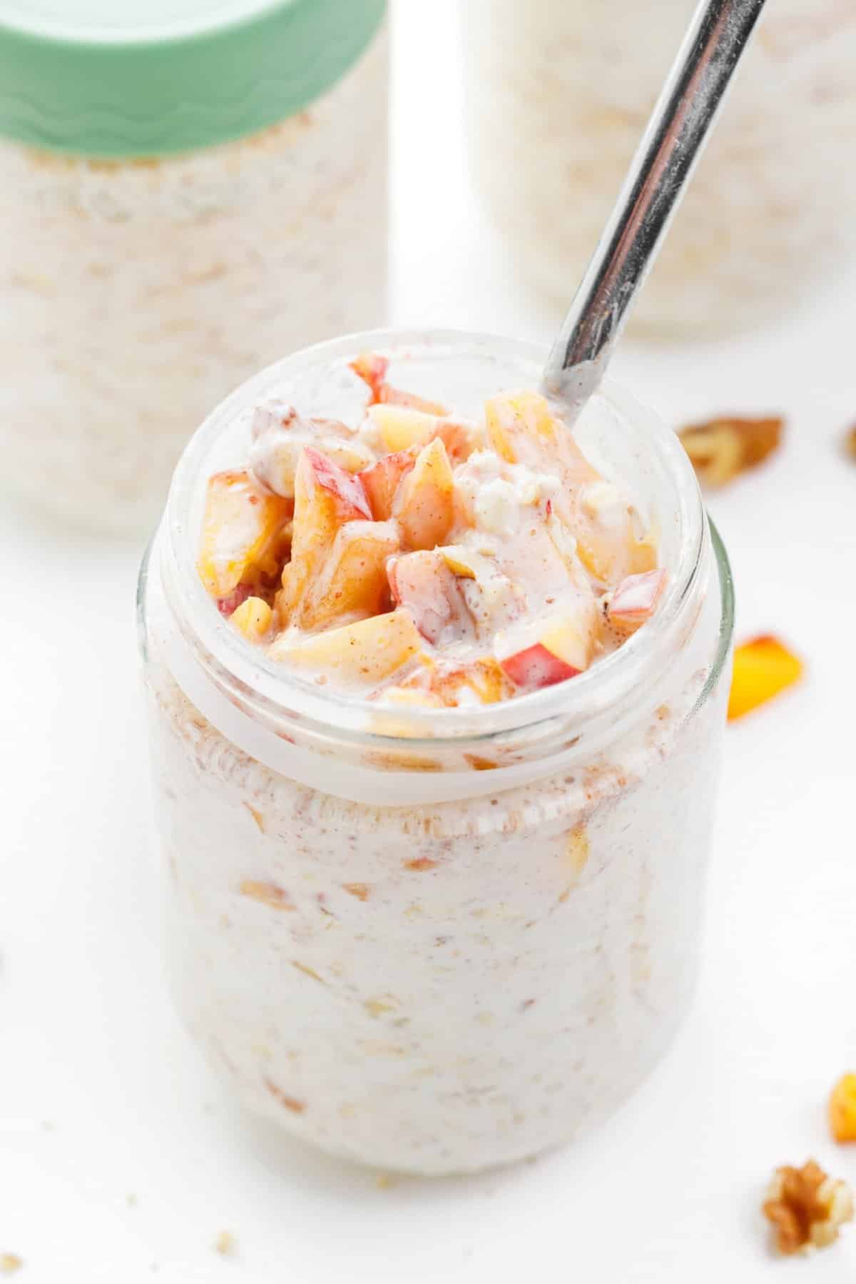 Jar full of peaches and cream overnight oats.