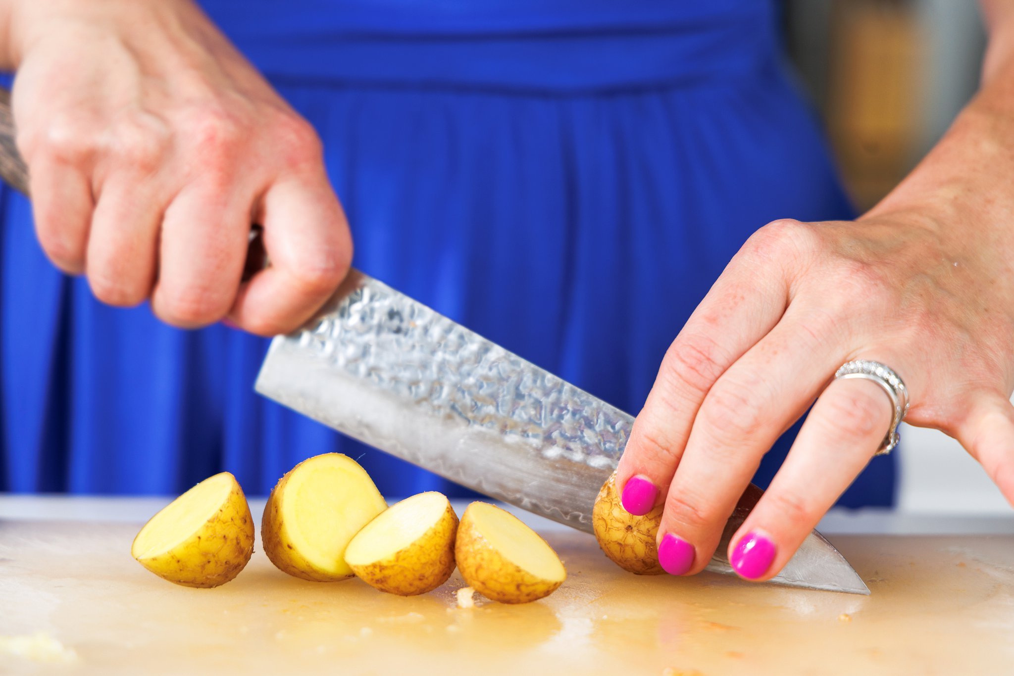 Liz cutting small potatoes in half.