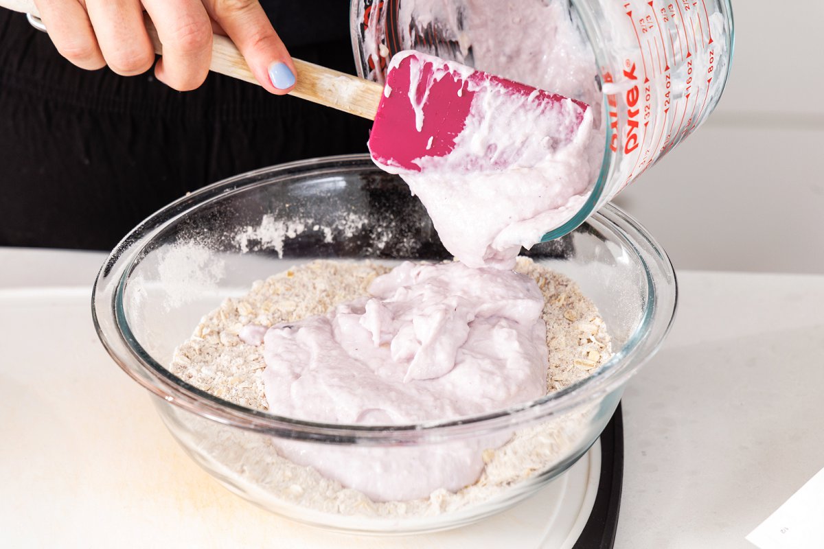 Adding blueberry yogurt to dry ingredients.