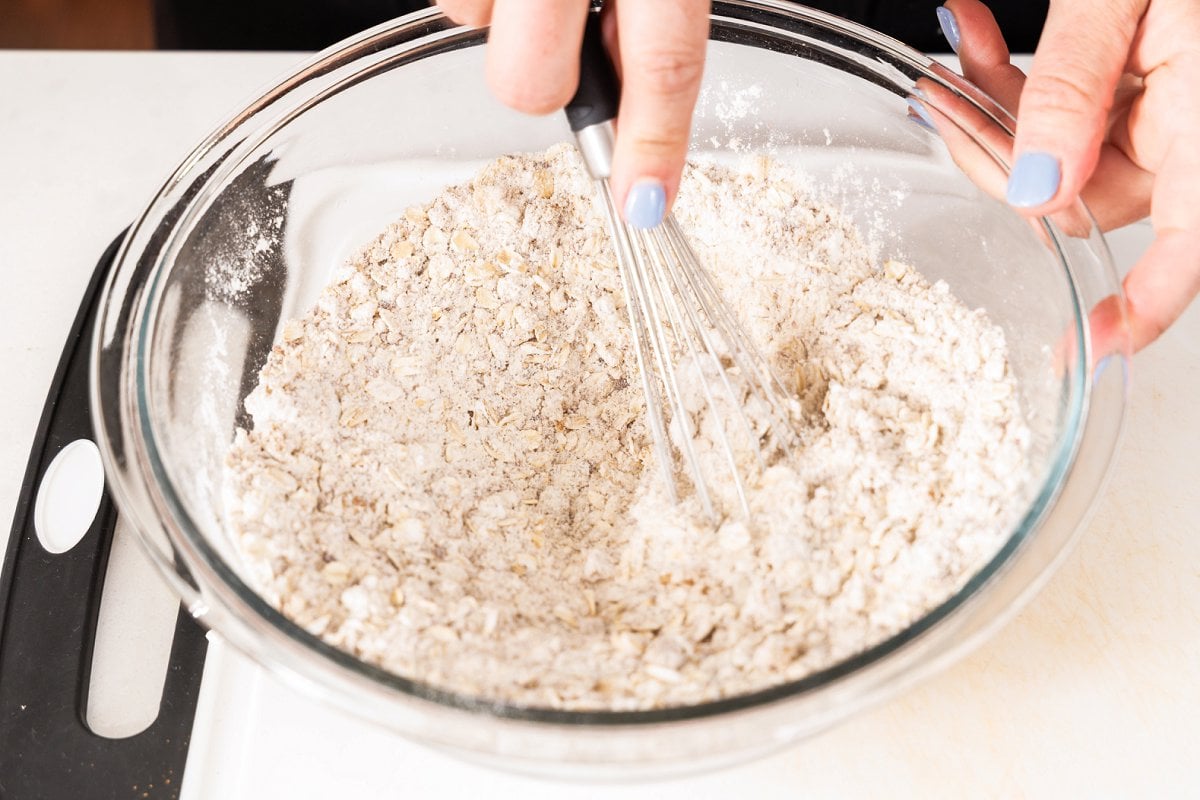 Whisking dry ingredients in a large glass bowl