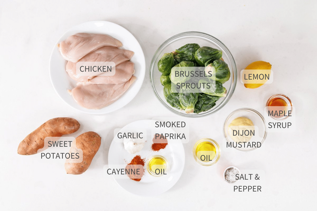 Labeled ingredients for maple dijon chicken with roasted fall veggies on a white counter.