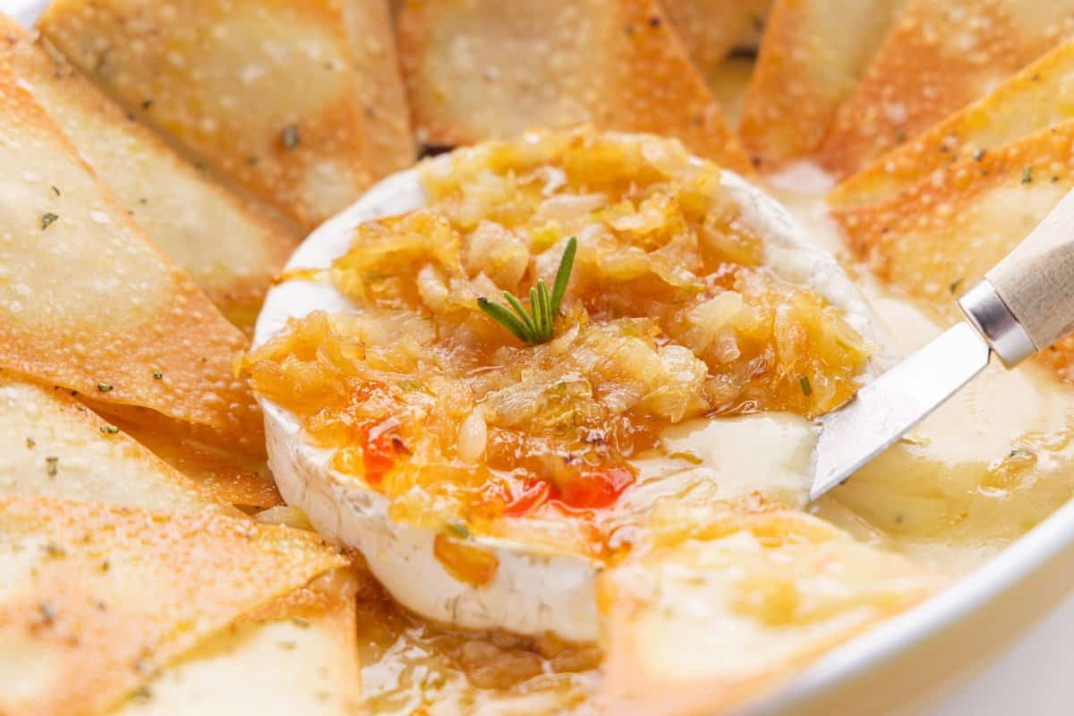 Baked brie with caramelized onions and pepper jelly with baked wonton crackers.