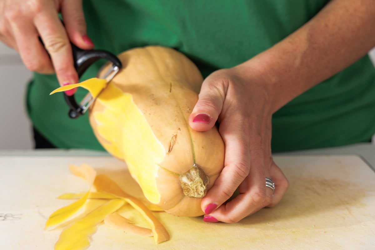 Peeling butternut squash.