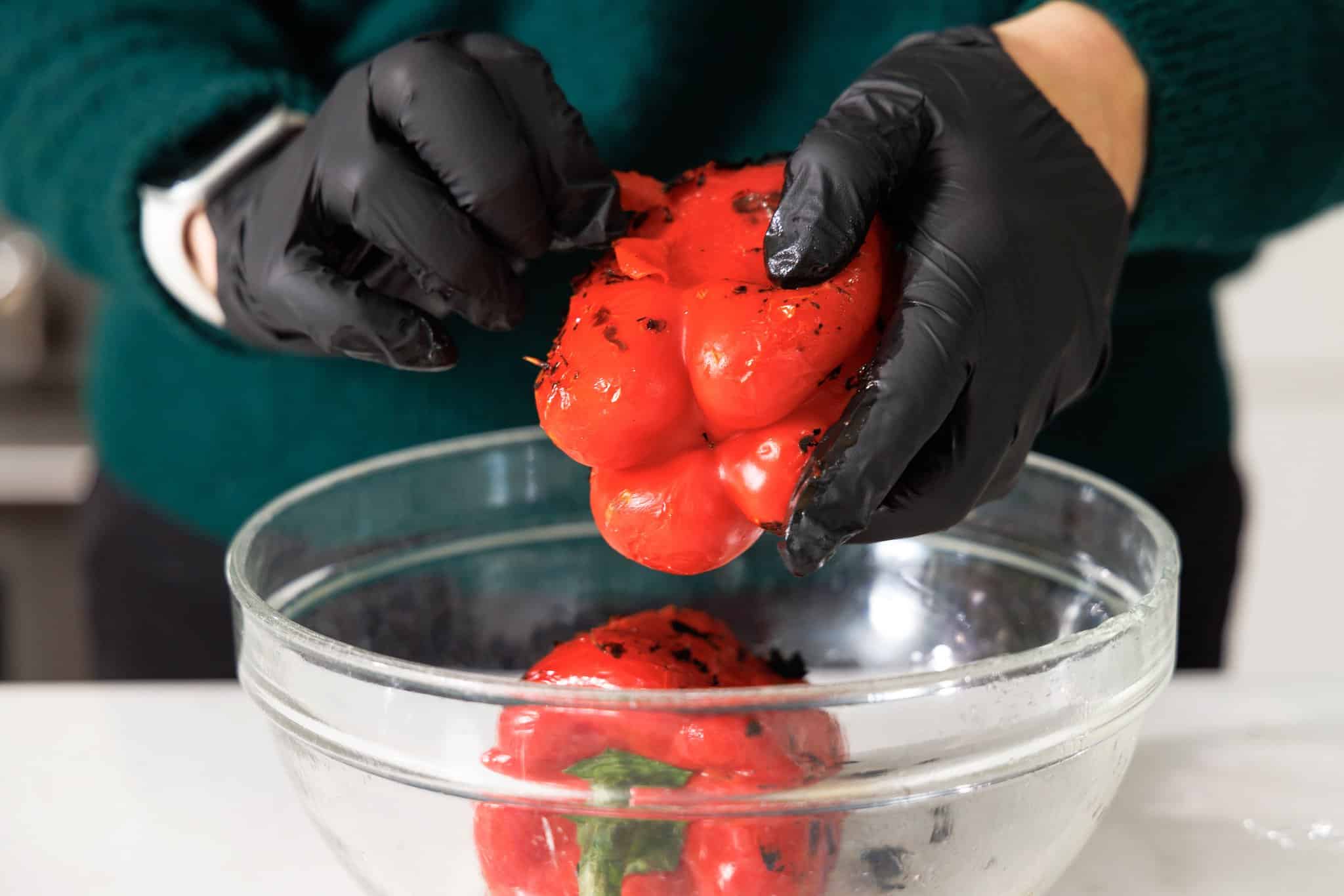 Wearing gloves to peel charred skin off of roasted pepper.